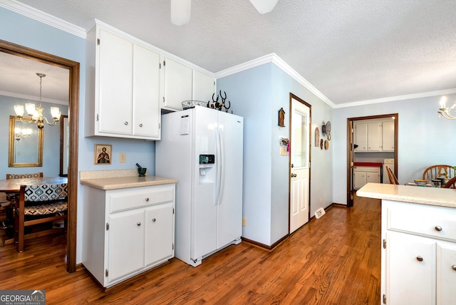 kitchen featuring an inviting chandelier, white cabinets, hanging light fixtures, white fridge with ice dispenser, and dark hardwood / wood-style flooring