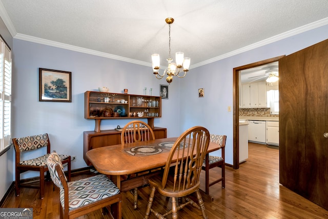 dining room with ceiling fan with notable chandelier, a textured ceiling, light hardwood / wood-style flooring, and ornamental molding