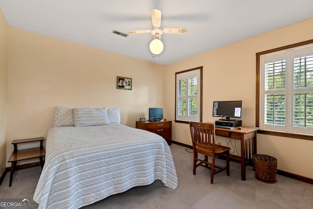 bedroom with ceiling fan and light carpet