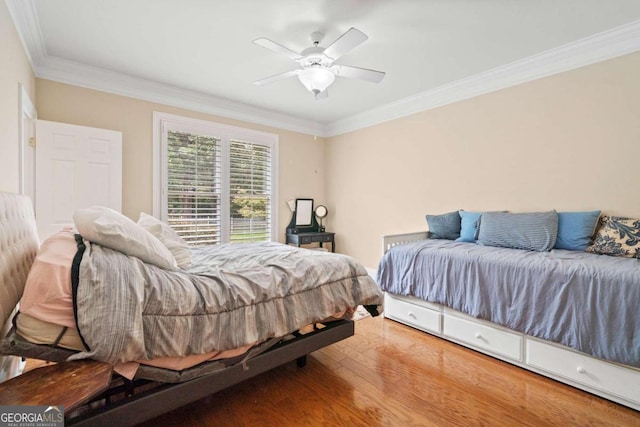 bedroom featuring wood-type flooring, ceiling fan, and ornamental molding