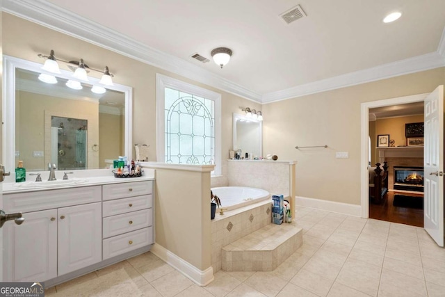 bathroom with tile patterned flooring, a relaxing tiled tub, crown molding, and vanity