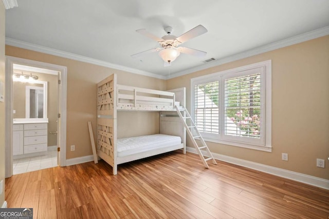 bedroom with ensuite bathroom, ceiling fan, hardwood / wood-style flooring, and crown molding