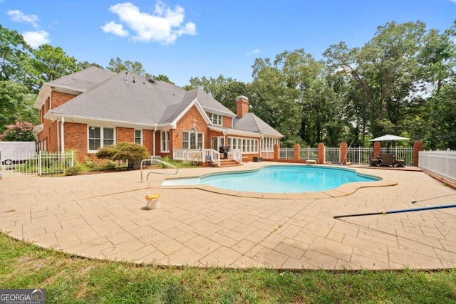 view of pool with a deck and a patio area