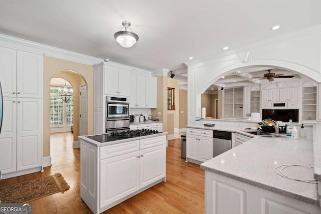 kitchen featuring white cabinets, ceiling fan, ornamental molding, and kitchen peninsula