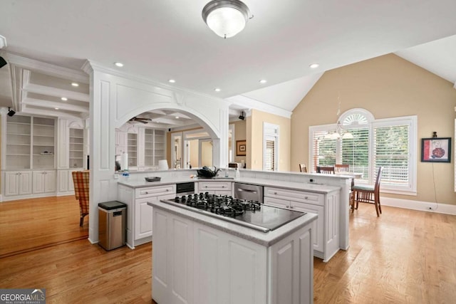 kitchen with white cabinets, gas cooktop, light hardwood / wood-style flooring, and kitchen peninsula