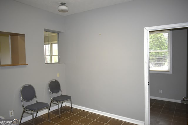 unfurnished room featuring dark tile patterned flooring