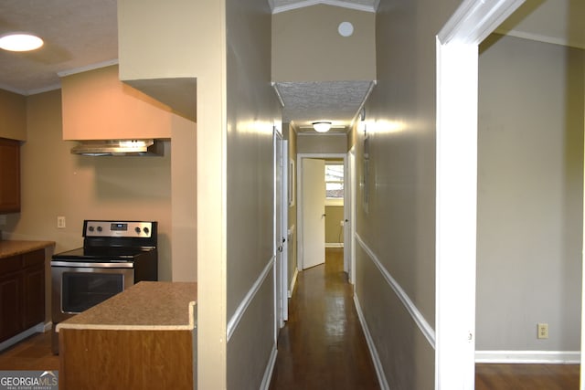 hallway featuring dark hardwood / wood-style flooring, vaulted ceiling, and crown molding