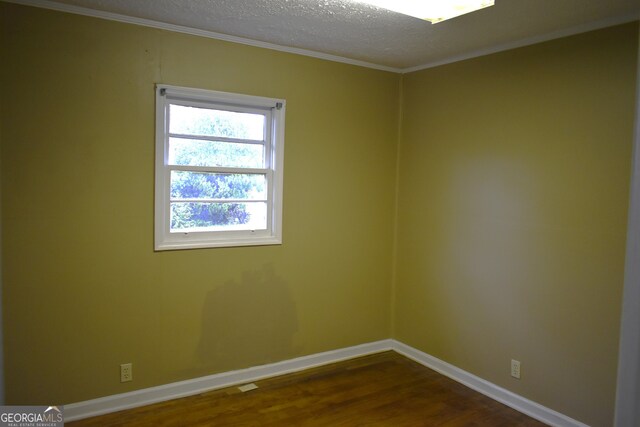 unfurnished room with crown molding, hardwood / wood-style floors, and a textured ceiling