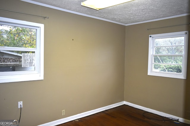 unfurnished room with a textured ceiling, dark hardwood / wood-style flooring, and crown molding