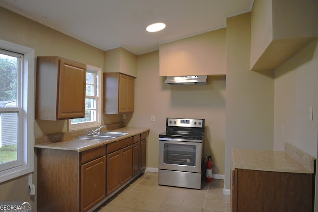 kitchen with stainless steel electric stove, sink, a healthy amount of sunlight, and ventilation hood