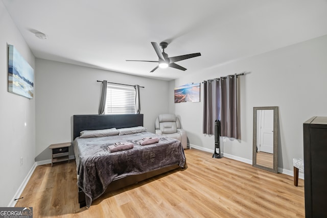 bedroom with ceiling fan and hardwood / wood-style flooring