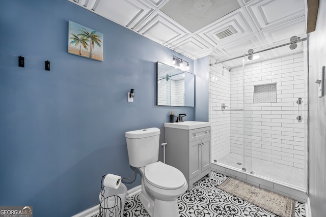 bathroom featuring tile patterned flooring, vanity, toilet, and a shower with door