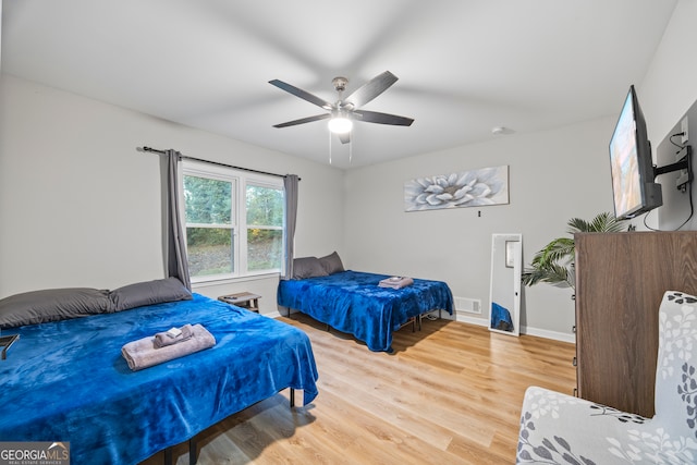 bedroom with hardwood / wood-style floors and ceiling fan