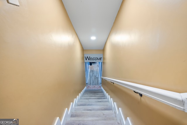 stairway with hardwood / wood-style flooring