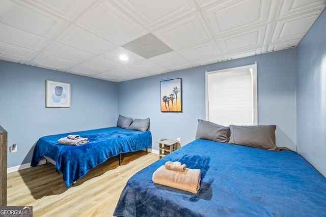 bedroom with hardwood / wood-style flooring