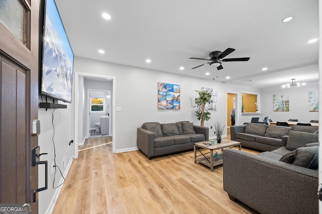 living room with light hardwood / wood-style floors and ceiling fan