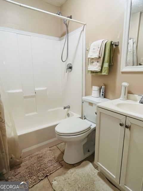 full bathroom with tile patterned flooring, vanity, toilet, and shower / bath combo with shower curtain