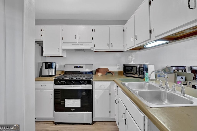 kitchen featuring white cabinetry, appliances with stainless steel finishes, sink, and light hardwood / wood-style flooring