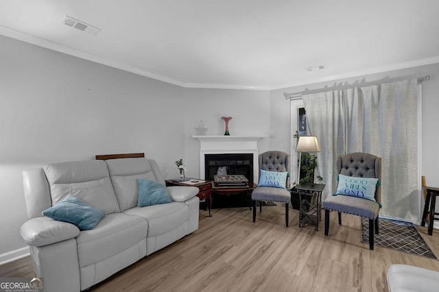 living room featuring light hardwood / wood-style flooring and ornamental molding