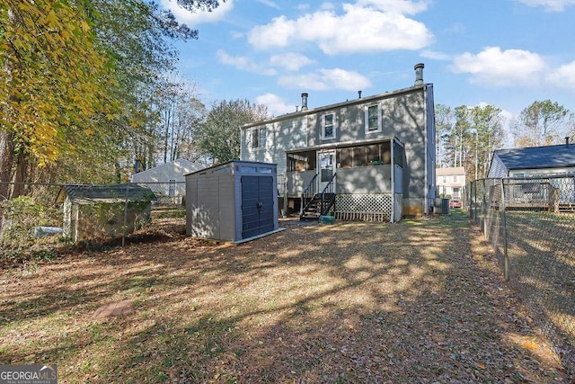 rear view of property with a storage unit