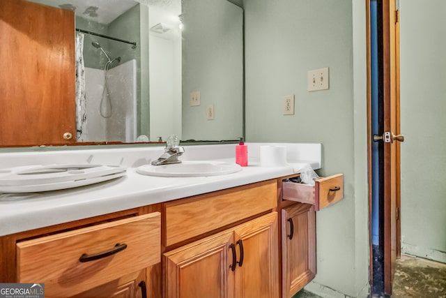 bathroom with a shower and vanity