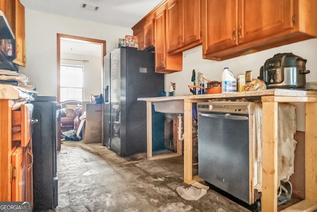 kitchen featuring dishwasher and black refrigerator with ice dispenser