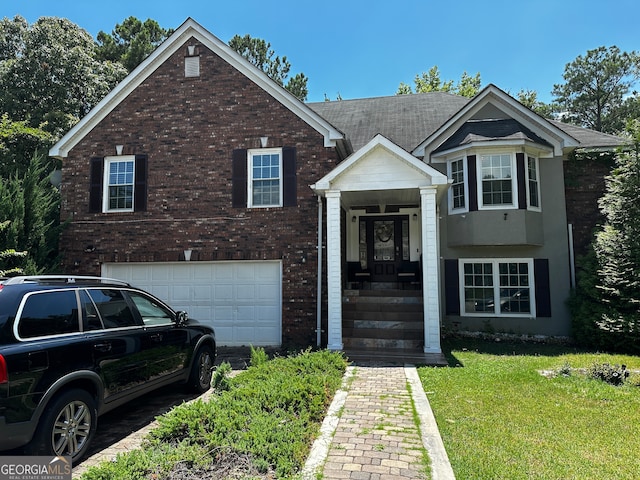 view of front facade featuring a front yard and a garage