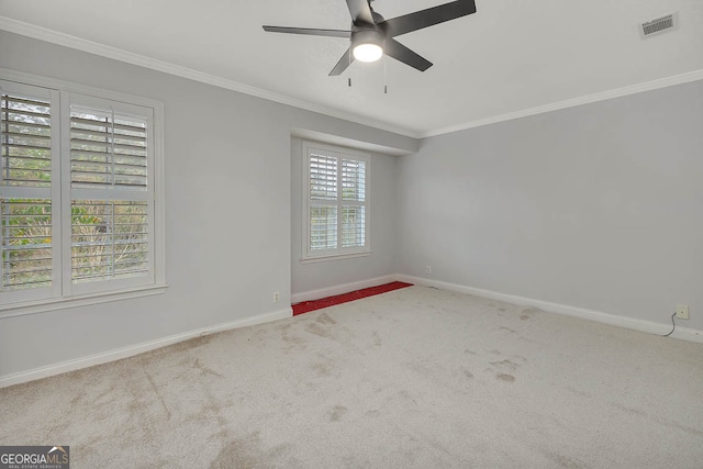 unfurnished room featuring carpet, crown molding, ceiling fan, and a healthy amount of sunlight