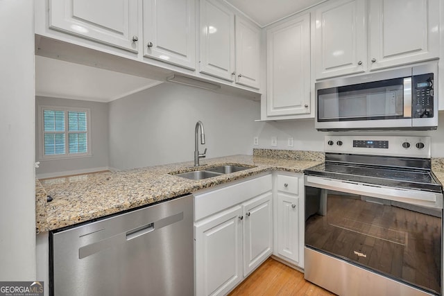 kitchen with sink, white cabinets, and stainless steel appliances