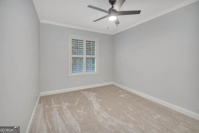 spare room with light carpet, ceiling fan, and ornamental molding