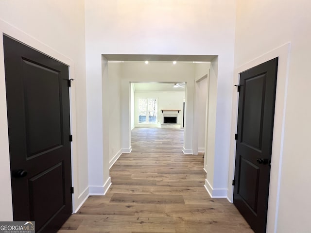 hallway with light hardwood / wood-style floors