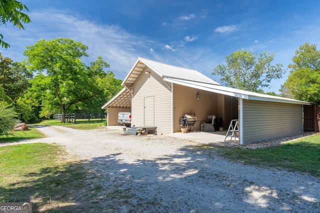 view of side of property with an outbuilding