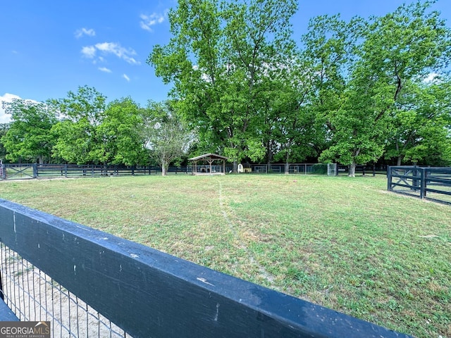 view of yard with a rural view