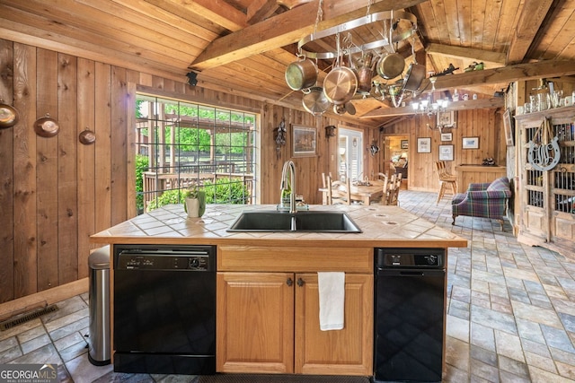 kitchen featuring tile countertops, lofted ceiling with beams, sink, and black dishwasher