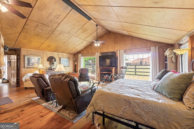 bedroom featuring hardwood / wood-style floors, ceiling fan, and lofted ceiling