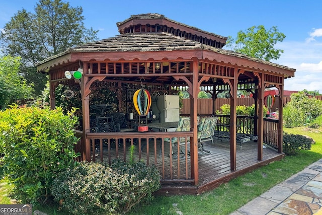 wooden terrace featuring a gazebo