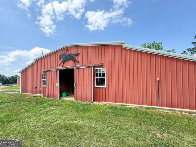 view of outbuilding with a yard