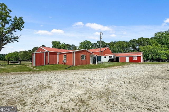 view of front of house featuring an outbuilding