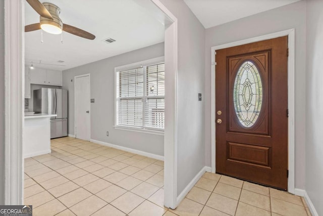 tiled foyer with ceiling fan and a wealth of natural light