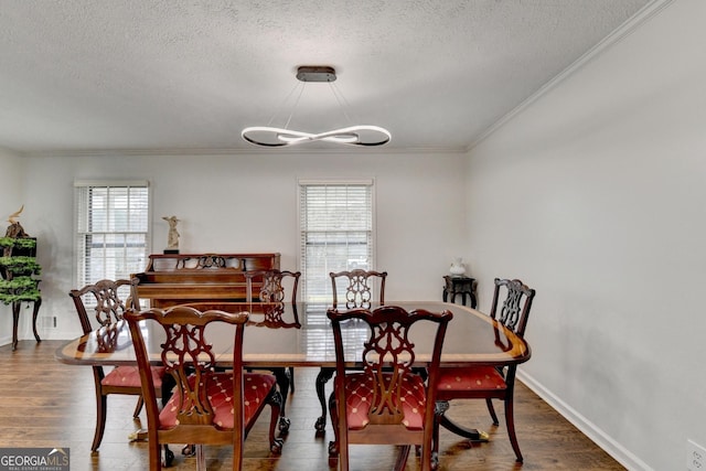 dining room featuring a textured ceiling, plenty of natural light, dark hardwood / wood-style flooring, and crown molding