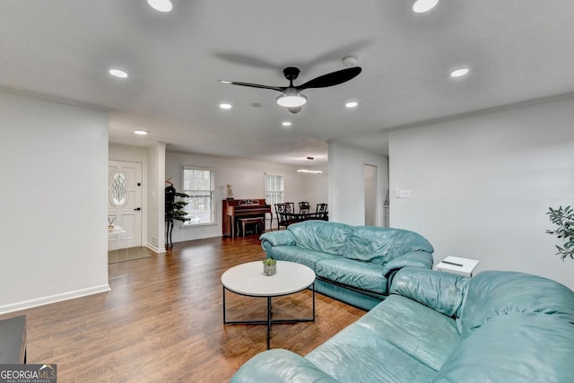 living room with dark hardwood / wood-style flooring and ceiling fan