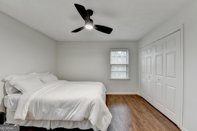 bedroom with ceiling fan, dark hardwood / wood-style flooring, and a closet