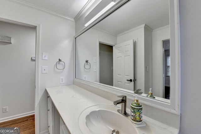 bathroom with vanity, hardwood / wood-style flooring, and ornamental molding