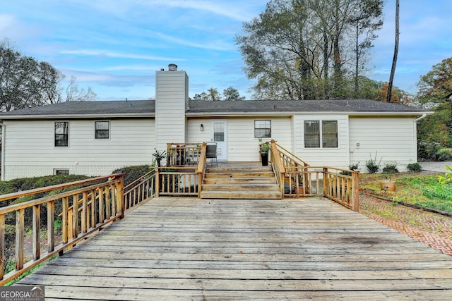 back of house with a wooden deck