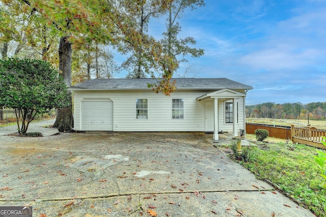 rear view of property featuring a garage