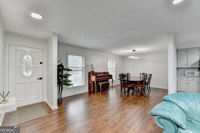 entryway with crown molding and dark hardwood / wood-style floors