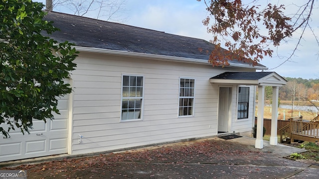 back of house with a garage