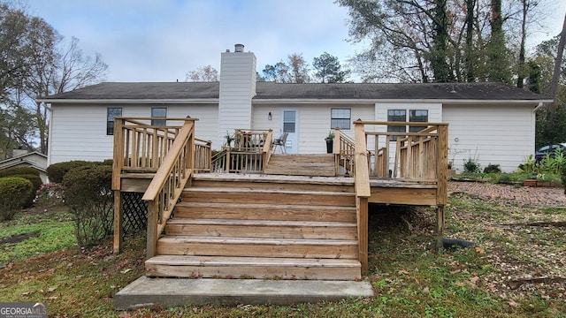 rear view of property with a wooden deck