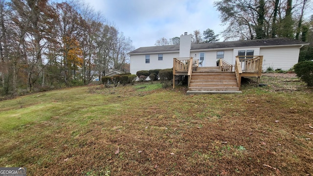 back of property with a lawn and a wooden deck