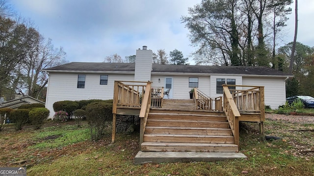 rear view of house with a wooden deck